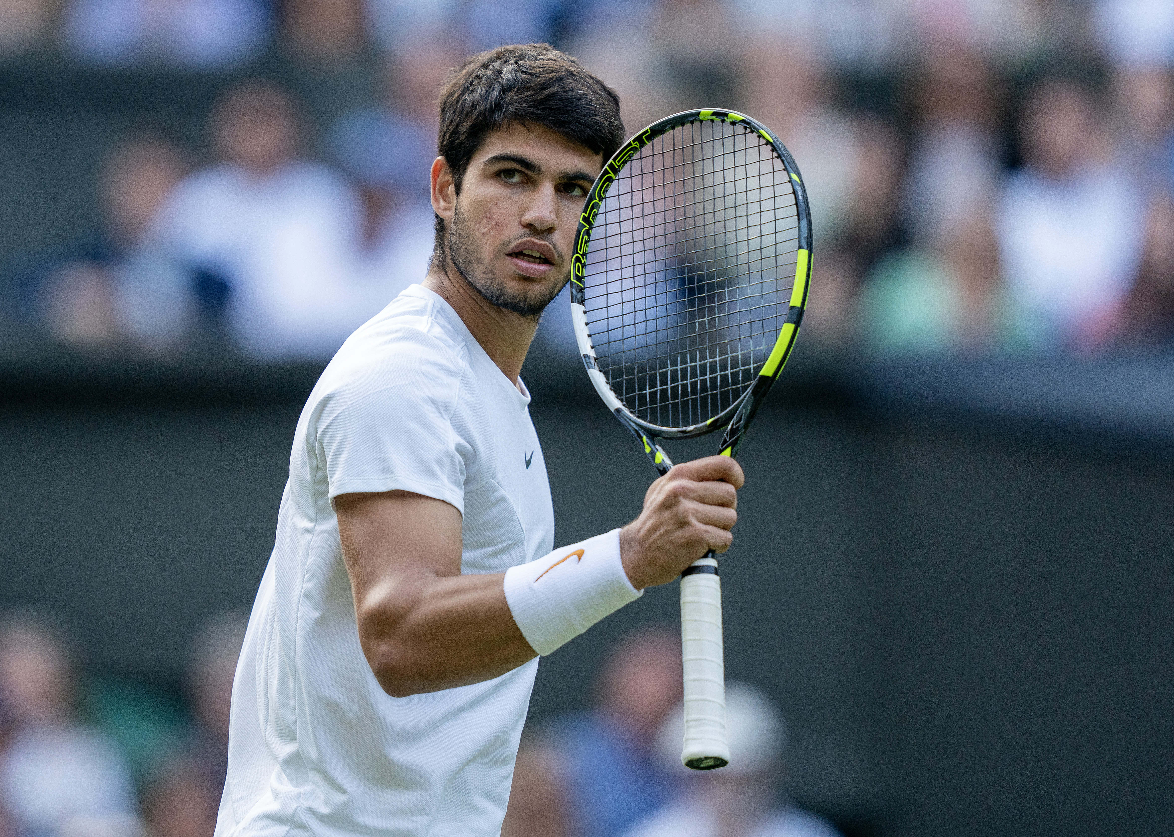 Jul 12, 2023; London, United Kingdom; Carlos Alcaraz (ESP) reacts to a point during his match against Holger Rune (DEN) on day ten of Wimbledon at the All England Lawn Tennis and Croquet Club.