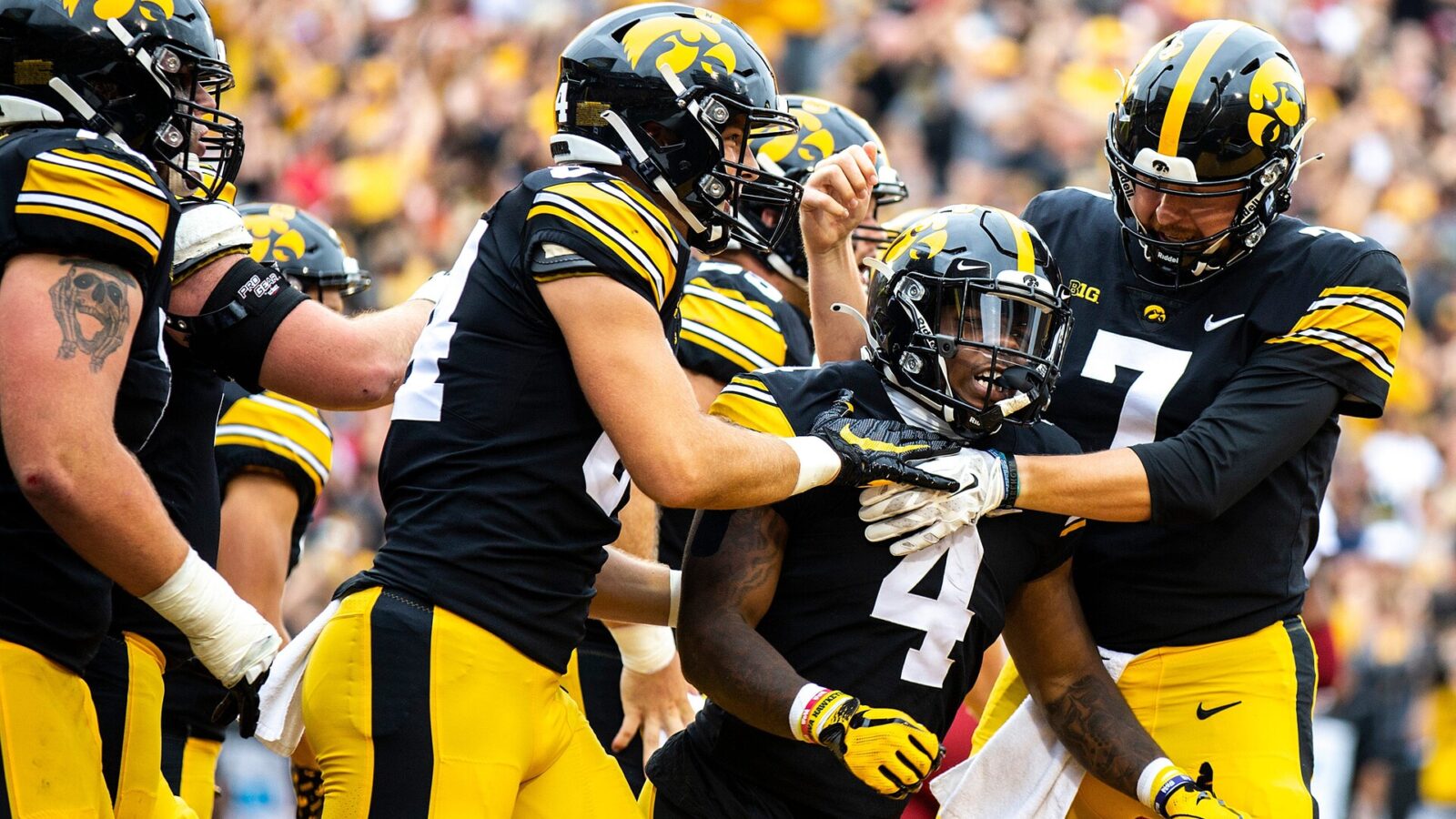 Iowa running back Leshon Williams (4) gets embraced by teammates tight end Sam LaPorta, left, and quarterback Spencer Petras (7) after scoring a touchdown during a NCAA football game against Iowa State, Saturday, Sept. 10, 2022, at Kinnick Stadium in Iowa City, Iowa.
