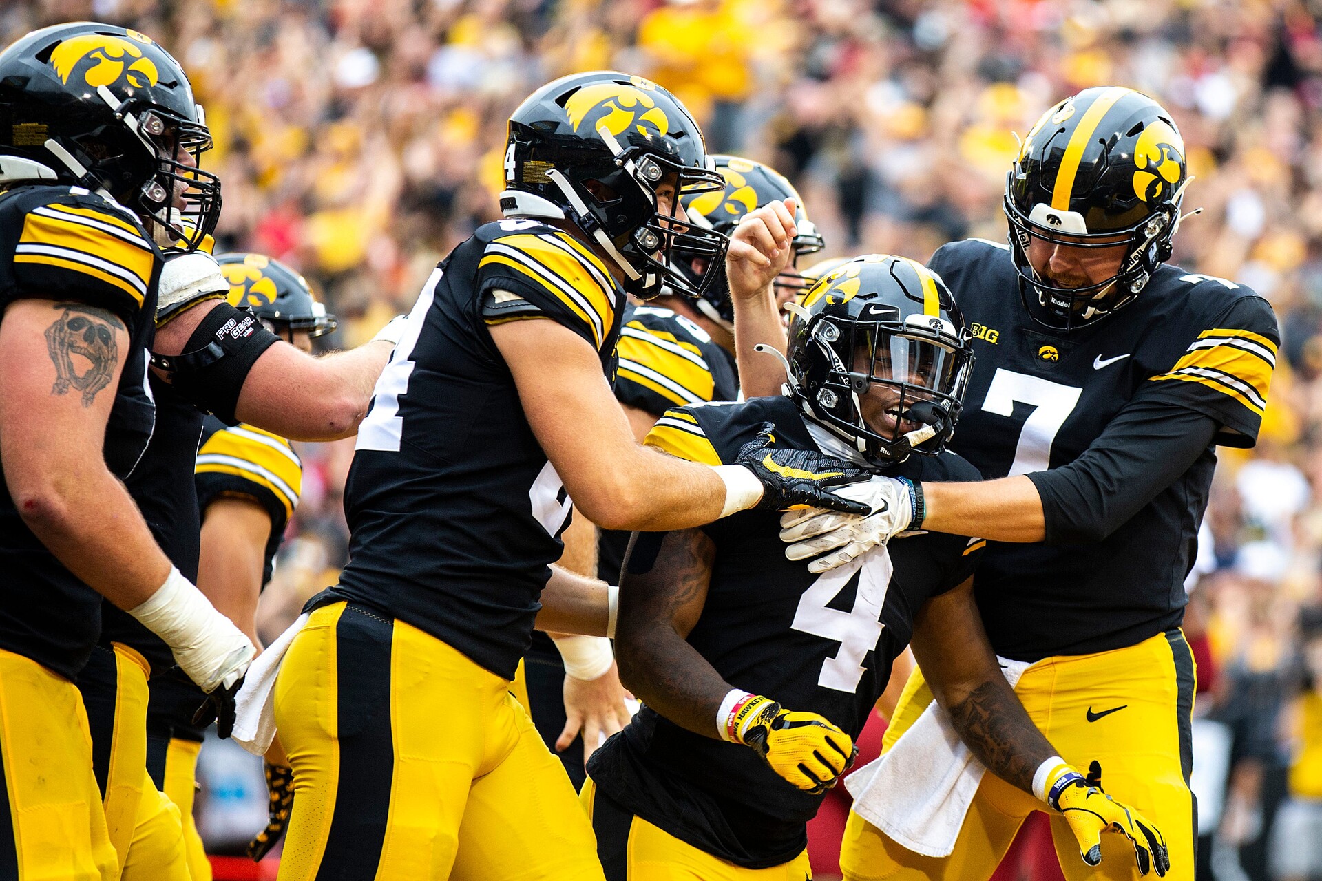 Iowa running back Leshon Williams (4) gets embraced by teammates tight end Sam LaPorta, left, and quarterback Spencer Petras (7) after scoring a touchdown during a NCAA football game against Iowa State, Saturday, Sept. 10, 2022, at Kinnick Stadium in Iowa City, Iowa.