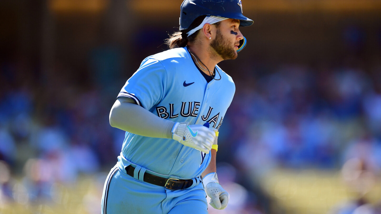 Jul 26, 2023; Los Angeles, California, USA; Toronto Blue Jays shortstop Bo Bichette (11) runs after hitting a two run RBI single against the Los Angeles Dodgers during the eighth inning at Dodger Stadium.