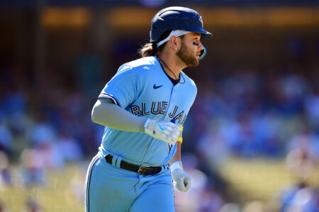 Jul 26, 2023; Los Angeles, California, USA; Toronto Blue Jays shortstop Bo Bichette (11) runs after hitting a two run RBI single against the Los Angeles Dodgers during the eighth inning at Dodger Stadium.