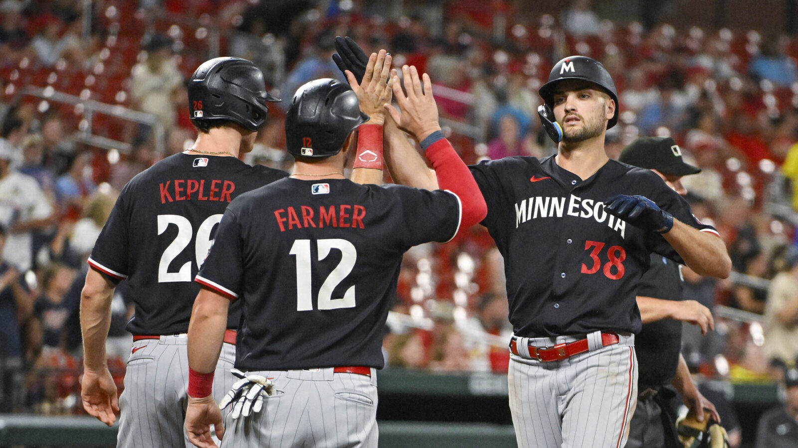 Aug 2, 2023; St. Louis, Missouri, USA; Minnesota Twins left fielder Matt Wallner (38) is congratulated by right fielder Max Kepler (26) and third baseman Kyle Farmer (12) after hitting a three run home run against the St. Louis Cardinals during the seventh inning at Busch Stadium.