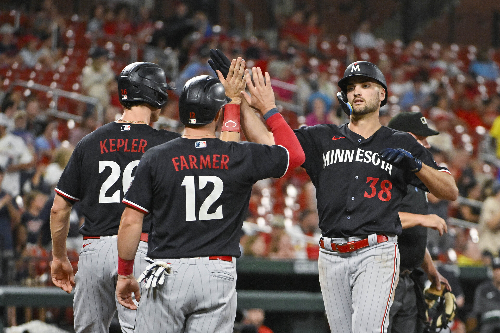 Aug 2, 2023; St. Louis, Missouri, USA; Minnesota Twins left fielder Matt Wallner (38) is congratulated by right fielder Max Kepler (26) and third baseman Kyle Farmer (12) after hitting a three run home run against the St. Louis Cardinals during the seventh inning at Busch Stadium.
