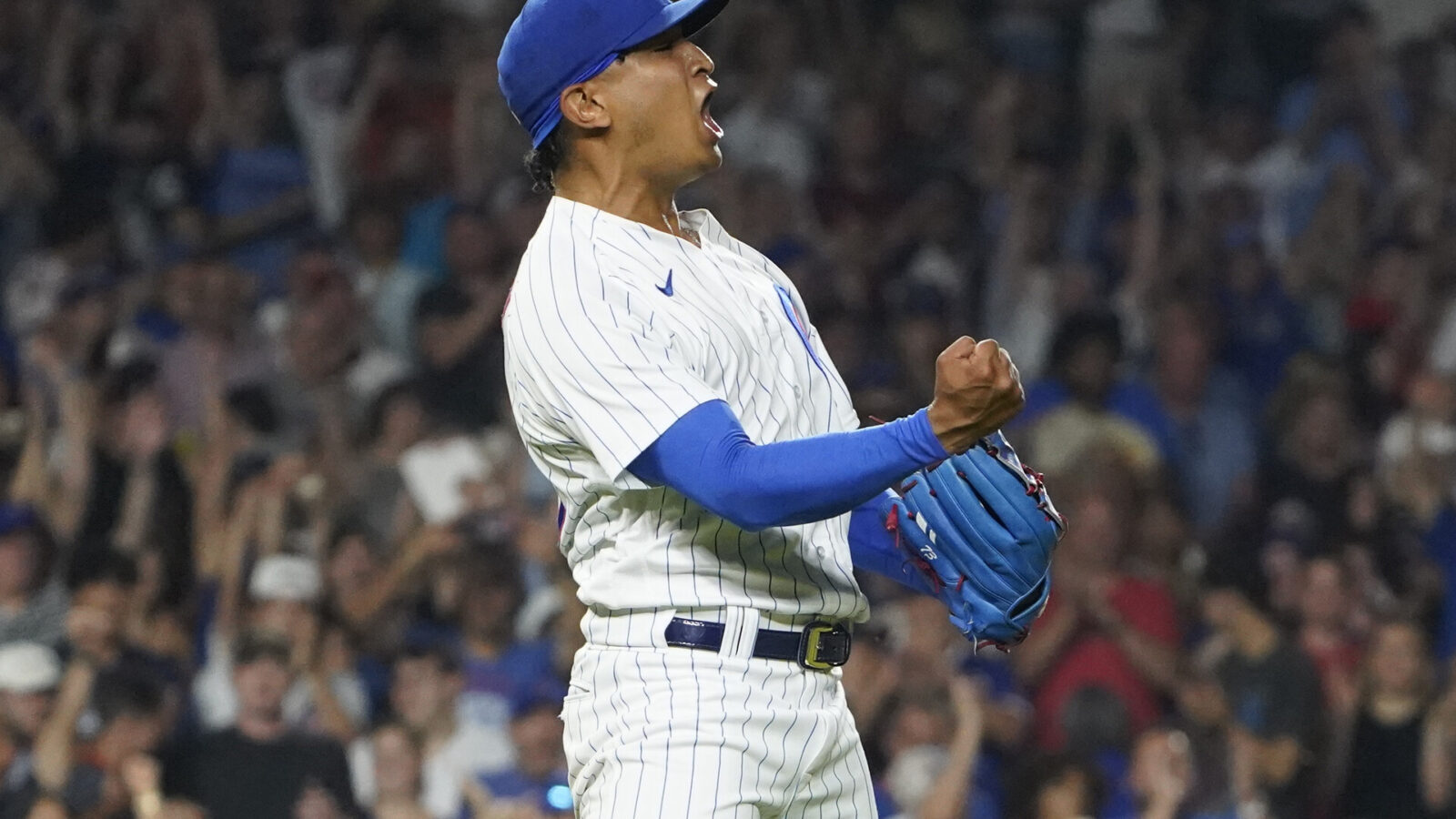 Aug 3, 2023; Chicago, Illinois, USA; Chicago Cubs relief pitcher Adbert Alzolay (73) celebrates the final out against the Cincinnati Reds during the ninth inning at Wrigley Field.