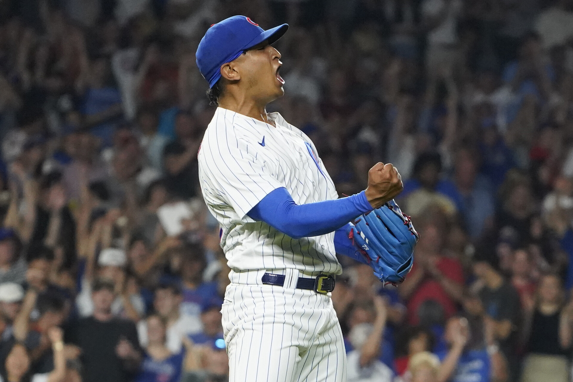 Aug 3, 2023; Chicago, Illinois, USA; Chicago Cubs relief pitcher Adbert Alzolay (73) celebrates the final out against the Cincinnati Reds during the ninth inning at Wrigley Field.