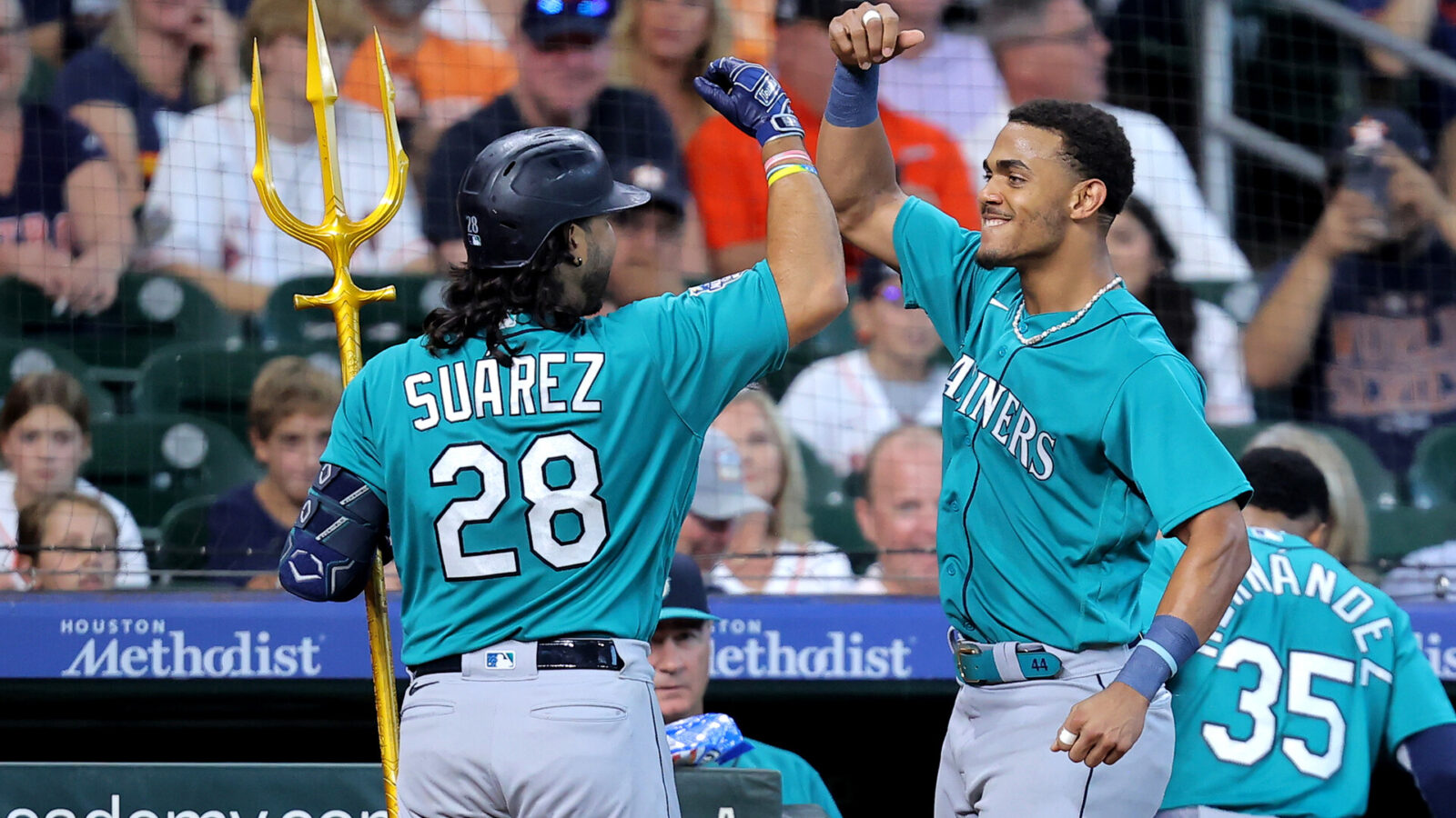 Aug 20, 2023; Houston, Texas, USA; Seattle Mariners third baseman Eugenio Suarez (28) is congratulated by Seattle Mariners center fielder Julio Rodriguez (44) after hitting a two-run home run to left field against the Houston Astros at Minute Maid Park.