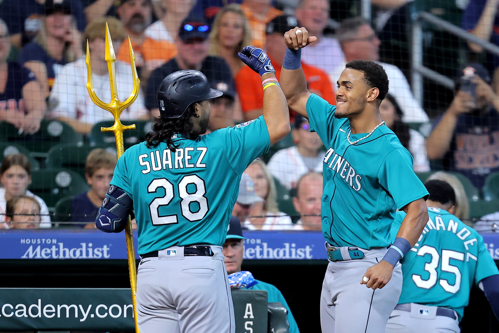 Aug 20, 2023; Houston, Texas, USA; Seattle Mariners third baseman Eugenio Suarez (28) is congratulated by Seattle Mariners center fielder Julio Rodriguez (44) after hitting a two-run home run to left field against the Houston Astros at Minute Maid Park.