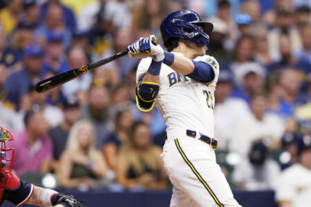 Aug 22, 2023; Milwaukee, Wisconsin, USA; Milwaukee Brewers left fielder Christian Yelich (22) hits a double during the third inning against the Minnesota Twins at American Family Field.