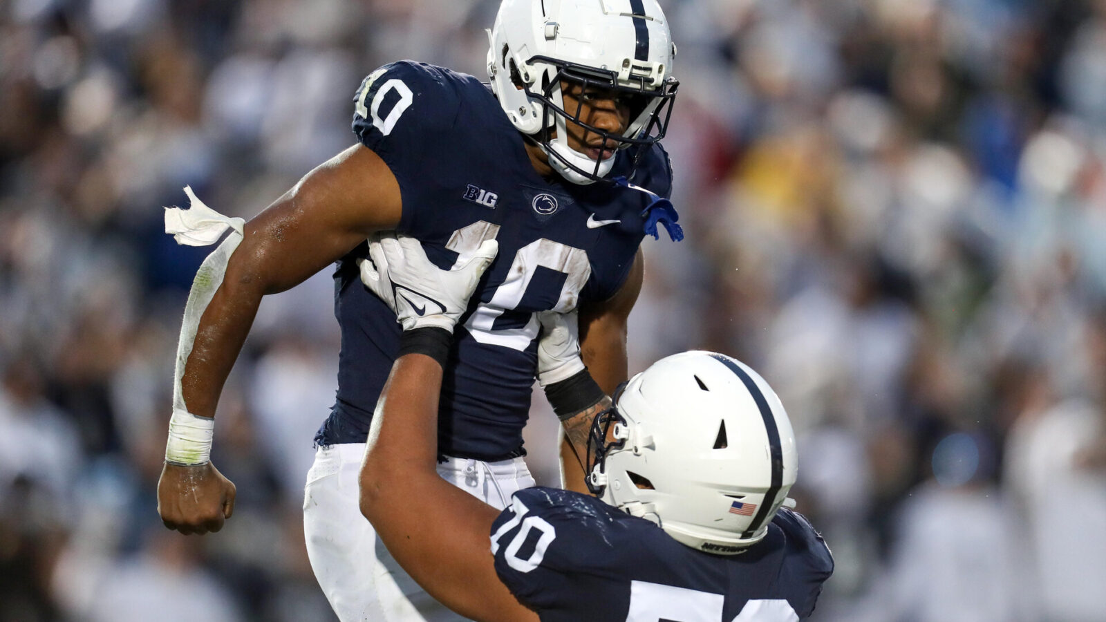 Penn State Nittany Lions running back Nicholas Singleton (10) celebrates with offensive linesman Juice Scruggs (70) after scoring a touchdown during the second quarter against the Maryland Terrapins at Beaver Stadium. Penn State defeated Maryland 30-0.