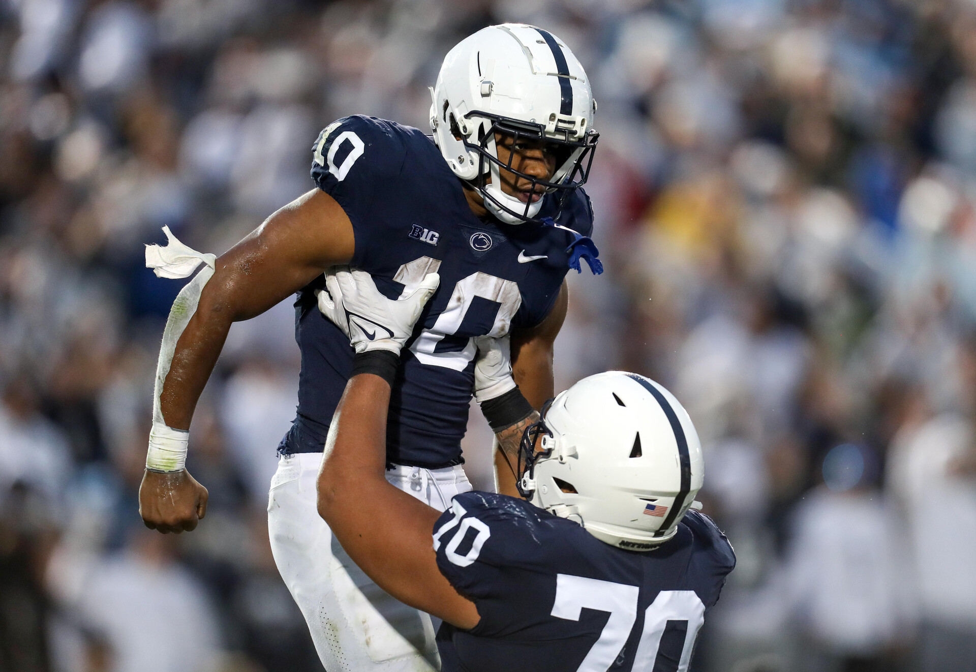 Penn State Nittany Lions running back Nicholas Singleton (10) celebrates with offensive linesman Juice Scruggs (70) after scoring a touchdown during the second quarter against the Maryland Terrapins at Beaver Stadium. Penn State defeated Maryland 30-0.
