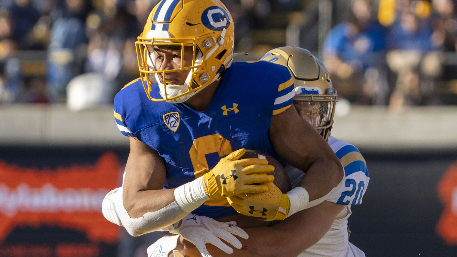 California Golden Bears running back Jaydn Ott (6) is tackled by UCLA Bruins linebacker Kain Medrano (20) during the second quarter at California Memorial Stadium.