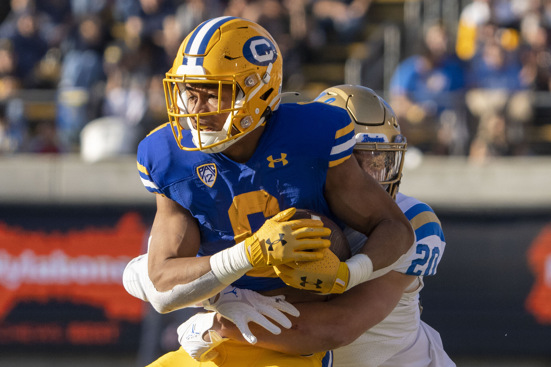 California Golden Bears running back Jaydn Ott (6) is tackled by UCLA Bruins linebacker Kain Medrano (20) during the second quarter at California Memorial Stadium.