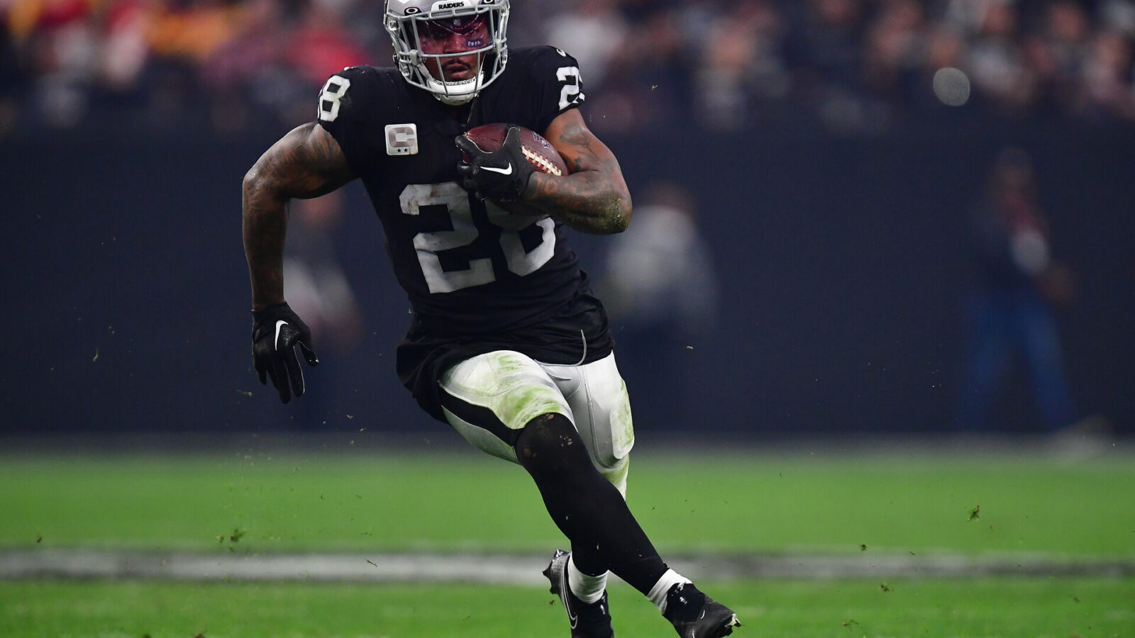 Jan 7, 2023; Paradise, Nevada, USA; Las Vegas Raiders running back Josh Jacobs (28) runs the ball against the Kansas City Chiefs during the second half at Allegiant Stadium.