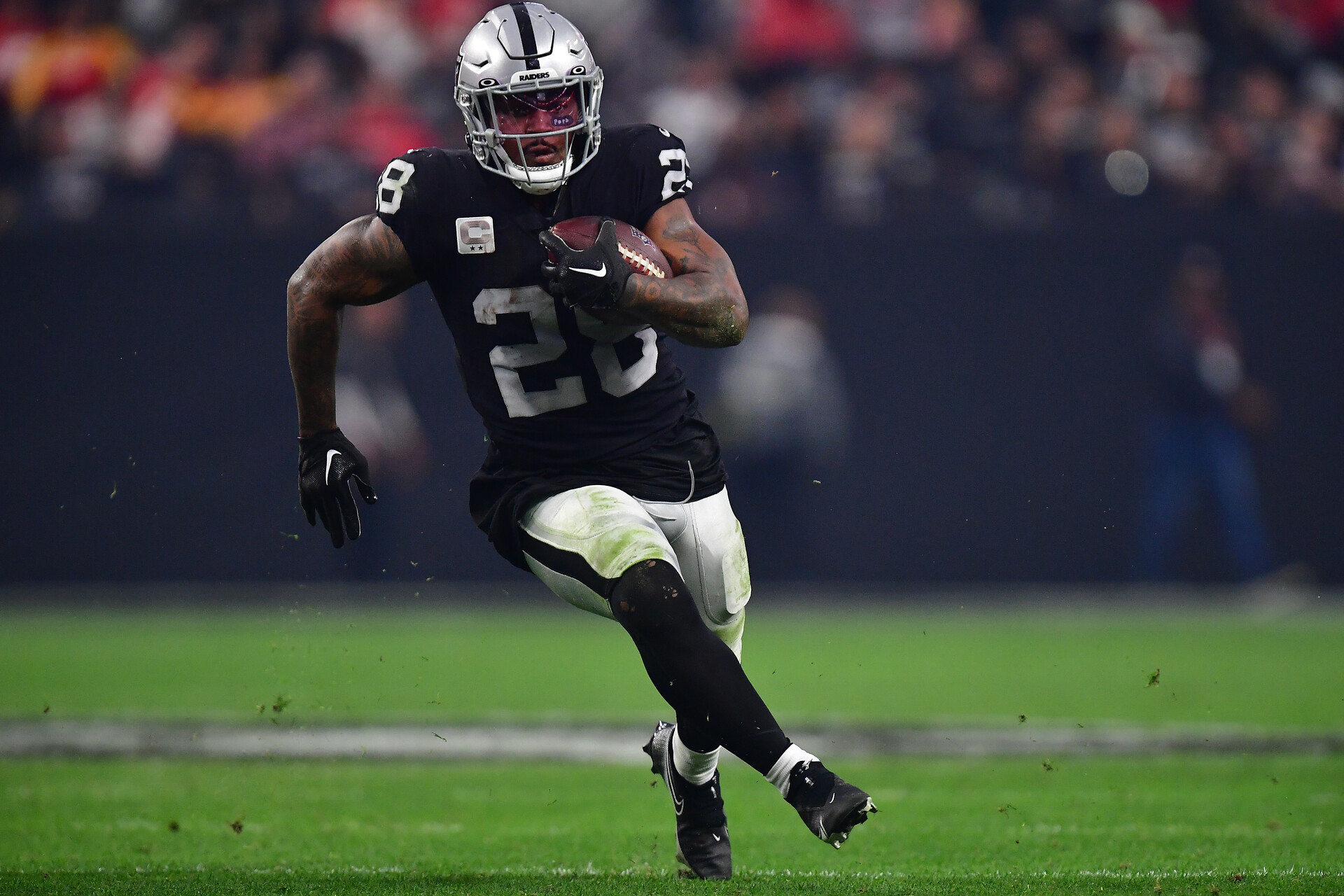 Jan 7, 2023; Paradise, Nevada, USA; Las Vegas Raiders running back Josh Jacobs (28) runs the ball against the Kansas City Chiefs during the second half at Allegiant Stadium.