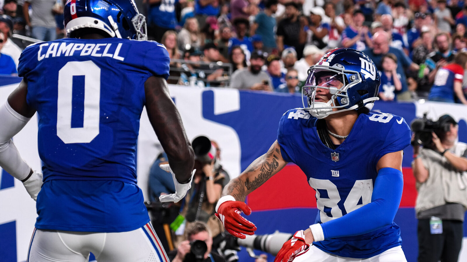 Aug 18, 2023; East Rutherford, New Jersey, USA; New York Giants wide receiver Jalin Hyatt (84) celebrates with New York Giants wide receiver Parris Campbell (0) after catching a touchdown pass against the Carolina Panthers during the second quarter at MetLife Stadium.