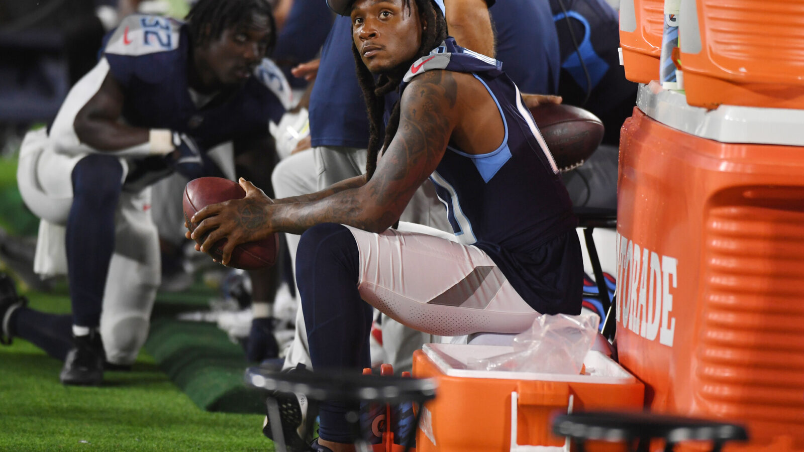 Aug 25, 2023; Nashville, Tennessee, USA; Tennessee Titans wide receiver DeAndre Hopkins (10) watches the game from the sidelines during the second half against the New England Patriots at Nissan Stadium.