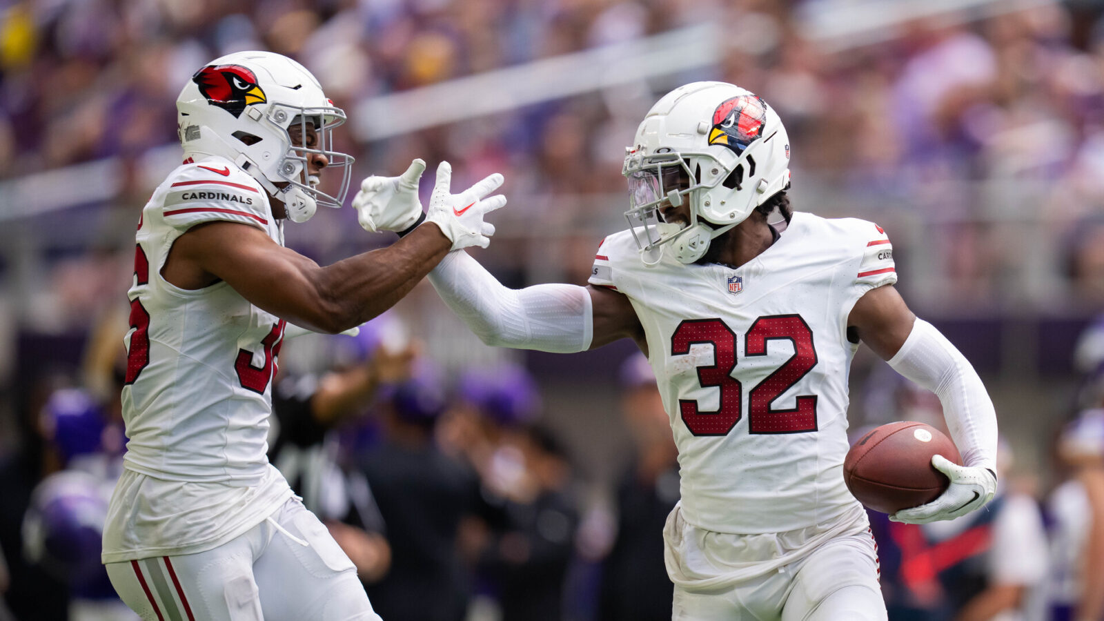 Aug 26, 2023; Minneapolis, Minnesota, USA; Arizona Cardinals safety Sean Chandler (32) celebrates with safety JuJu Hughes (36) after making an interception against the Minnesota Vikings in the fourth quarter at U.S. Bank Stadium.