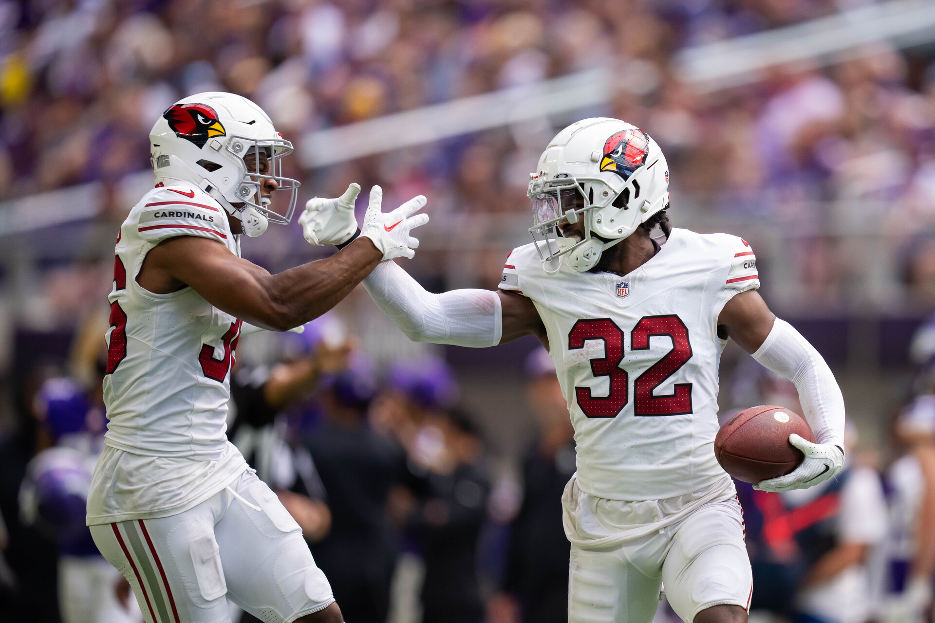Aug 26, 2023; Minneapolis, Minnesota, USA; Arizona Cardinals safety Sean Chandler (32) celebrates with safety JuJu Hughes (36) after making an interception against the Minnesota Vikings in the fourth quarter at U.S. Bank Stadium.