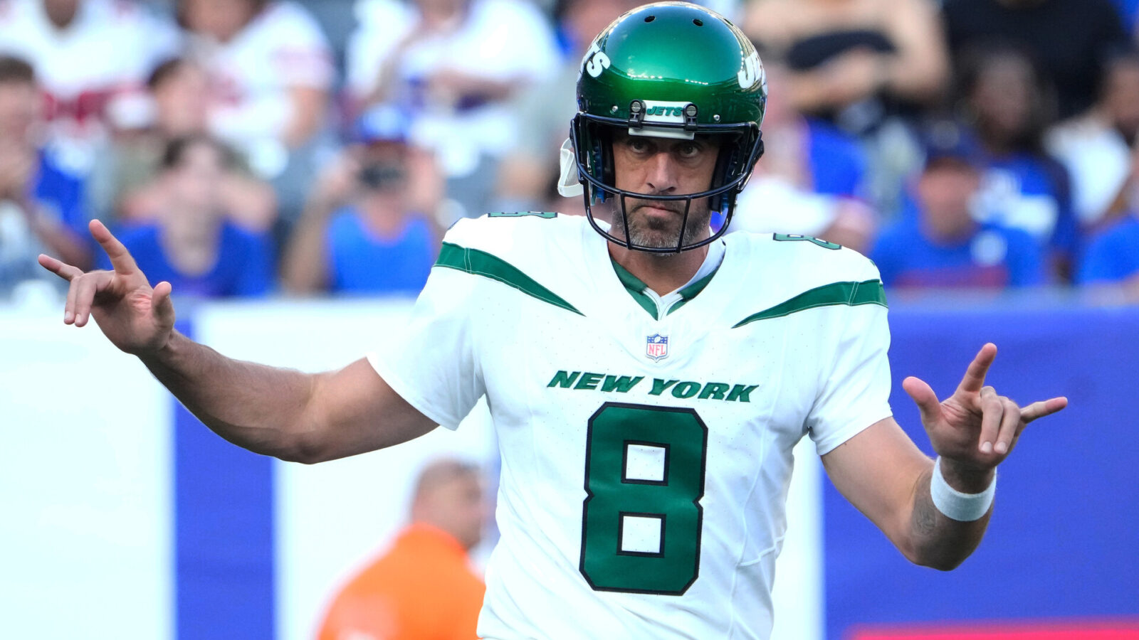 New York Jets quarterback Aaron Rodgers (8) greets the cheers of fans on his first appearance as a Jet against the Giants at MetLife Stadium.