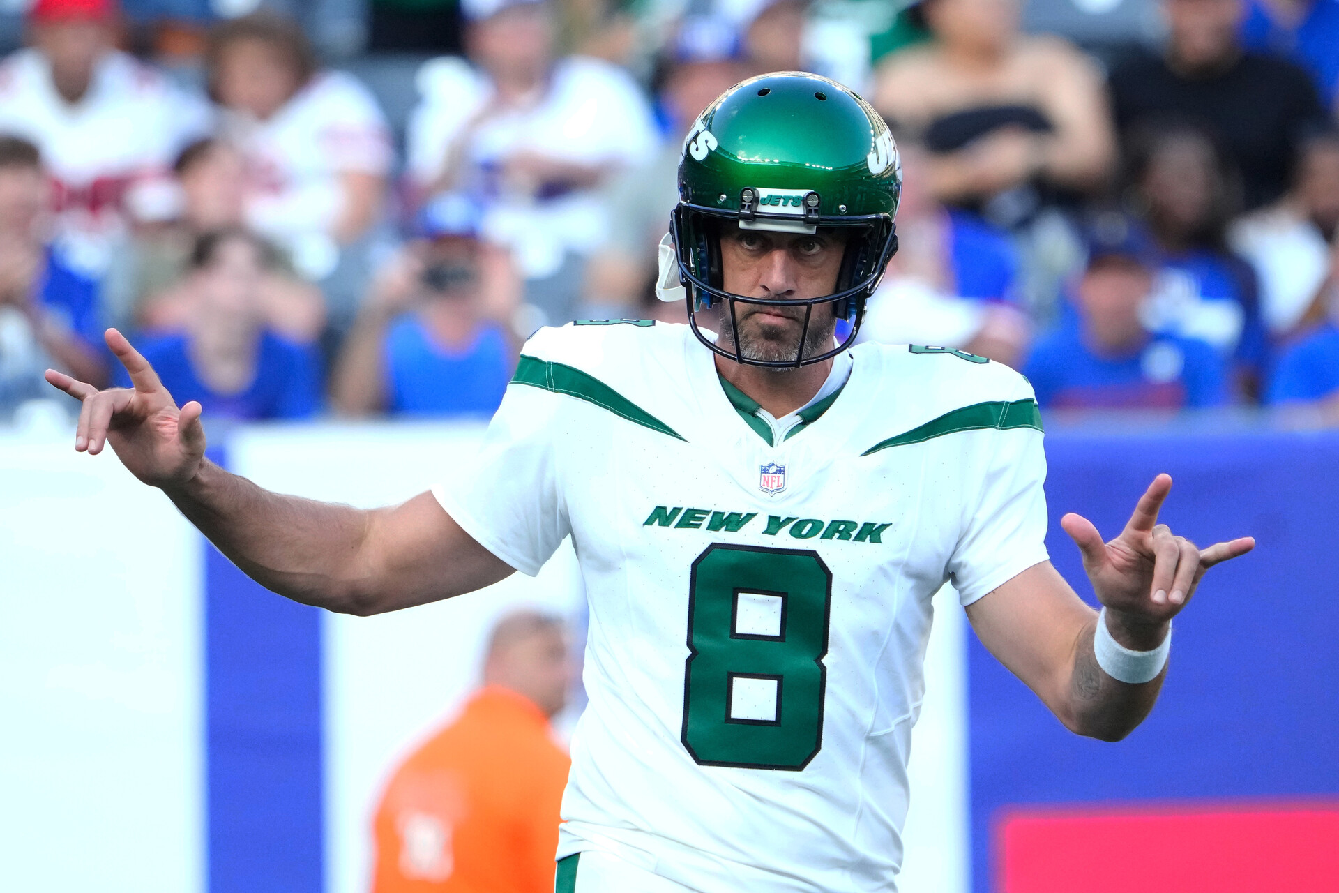 New York Jets quarterback Aaron Rodgers (8) greets the cheers of fans on his first appearance as a Jet against the Giants at MetLife Stadium.
