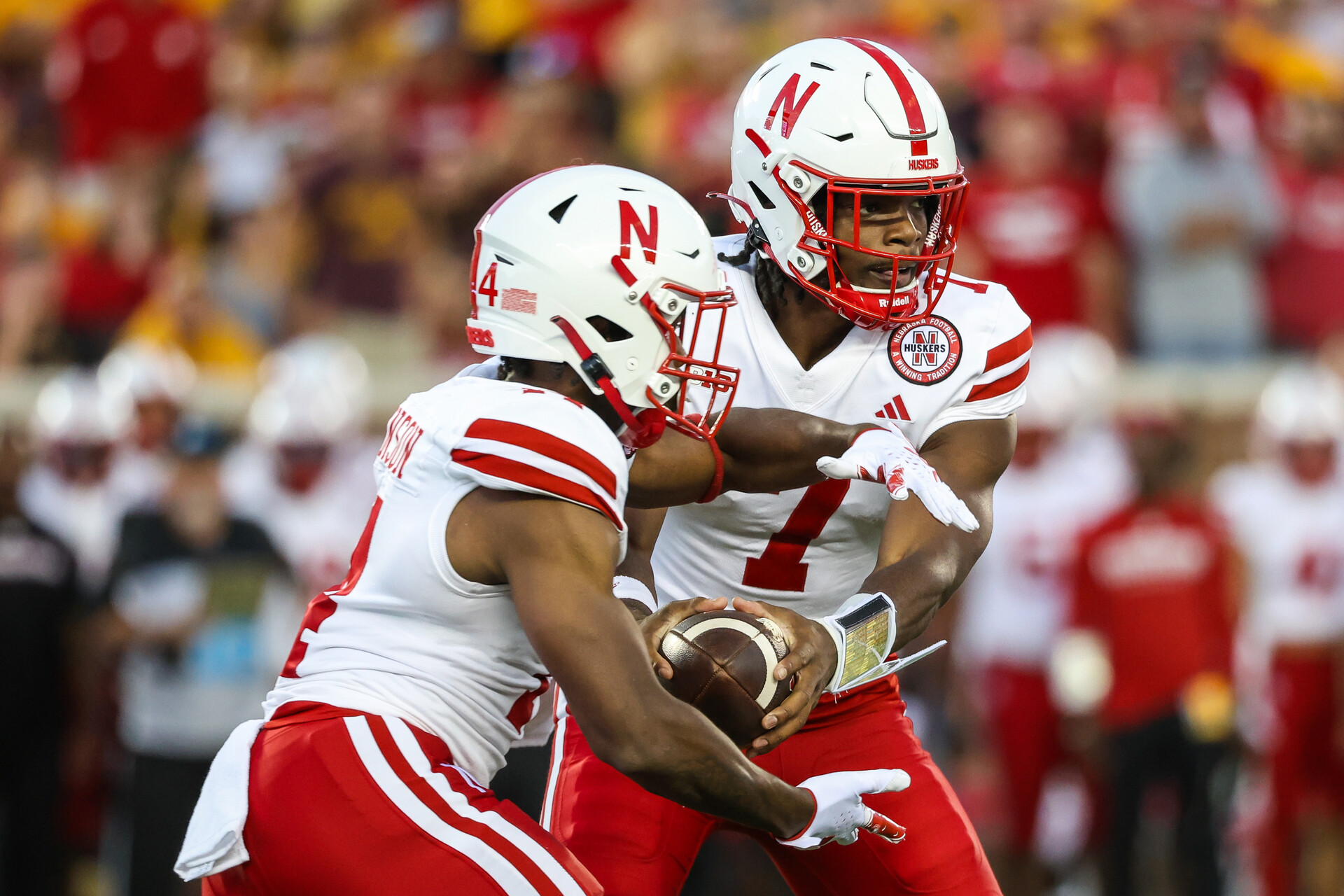 Nebraska Cornhuskers quarterback Jeff Sims (7) hands the ball off to running back Rahmir Johnson (14) during the second quarter against the Minnesota Golden Gophers at Huntington Bank Stadium.