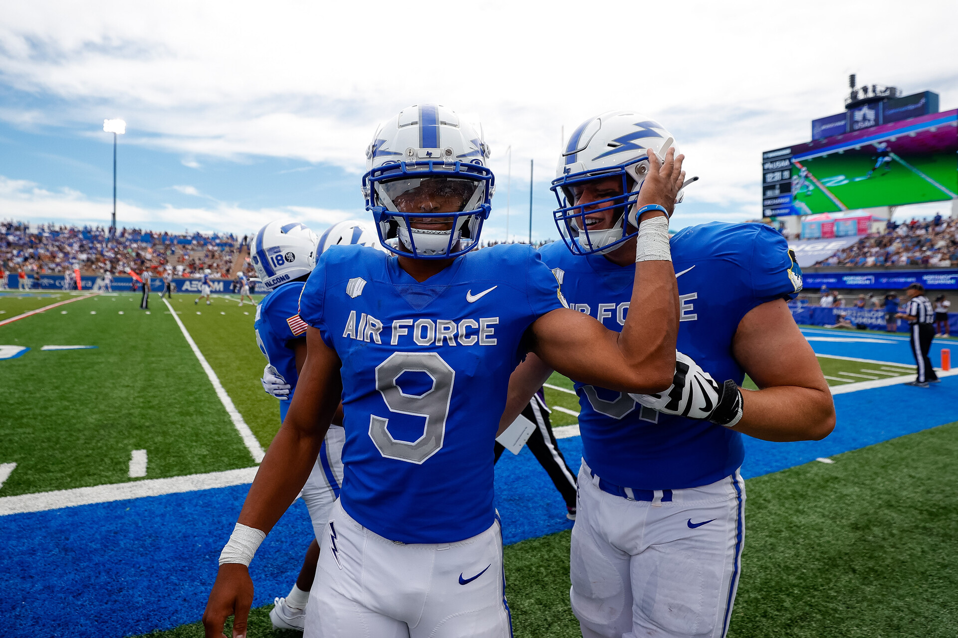 Zac Larrier (9) celebrates with offensive tackle Kaleb Holcomb (51) after a touchdown in the second quarter against the Robert Morris Colonials at Falcon Stadium.
