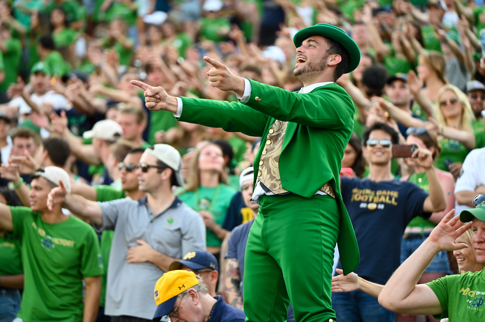The Notre Dame Fighting Irish leprechaun mascot leads the student section in cheering in the fourth quarter against the Tennessee State Tigers at Notre Dame Stadium.