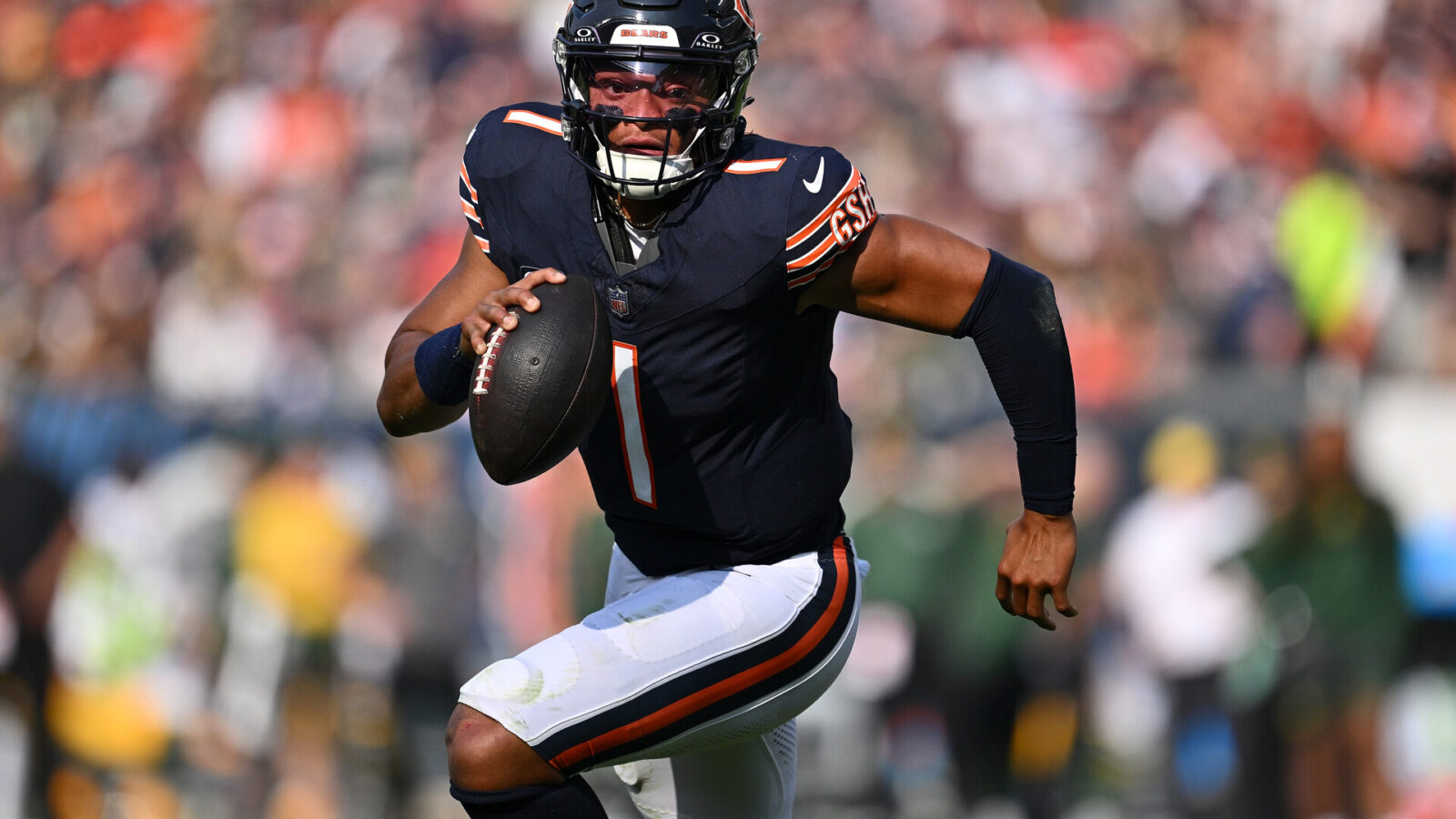 Sep 10, 2023; Chicago, Illinois, USA; Chicago Bears quarterback Justin Fields (1) runs the ball in the first half against the Green Bay Packers at Soldier Field.