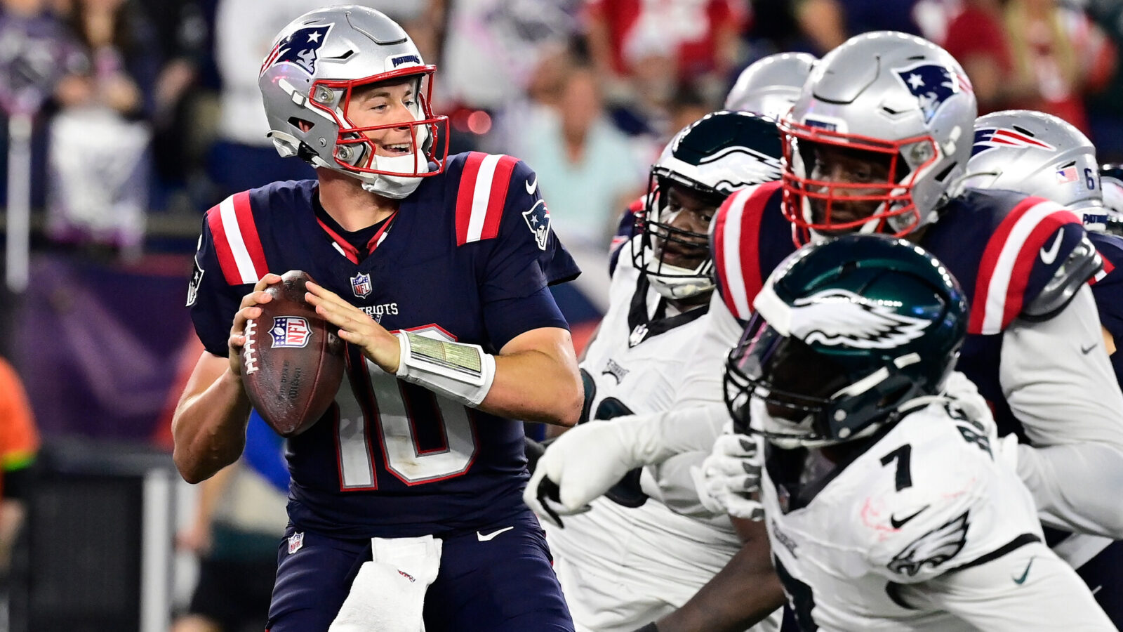 Sep 10, 2023; Foxborough, Massachusetts, USA; New England Patriots quarterback Mac Jones (10) tries to throw a pass as the Philadelphia Eagles close in during the second half at Gillette Stadium.