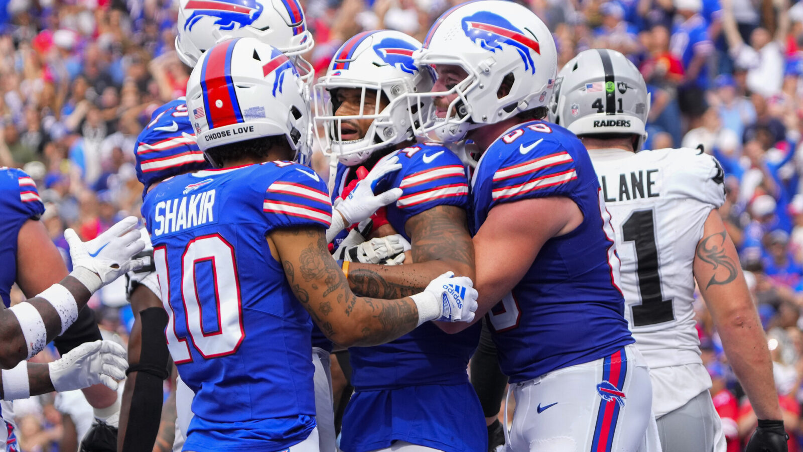 Buffalo Bills wide receiver Khalil Shakir (10) and tight end Dawson Knox (88) congratulate wide receiver Gabe Davis (13) for scoring a touchdown against the Las Vegas Raiders during the second half at Highmark Stadium.