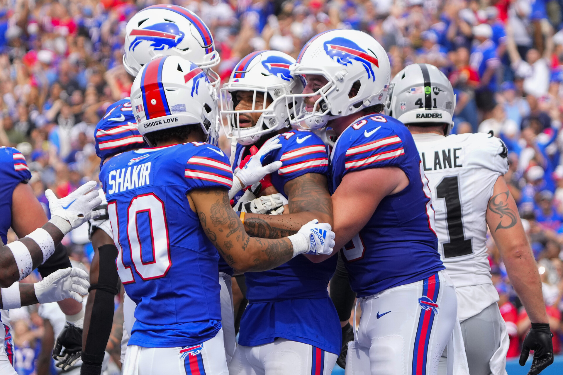 Buffalo Bills wide receiver Khalil Shakir (10) and tight end Dawson Knox (88) congratulate wide receiver Gabe Davis (13) for scoring a touchdown against the Las Vegas Raiders during the second half at Highmark Stadium.