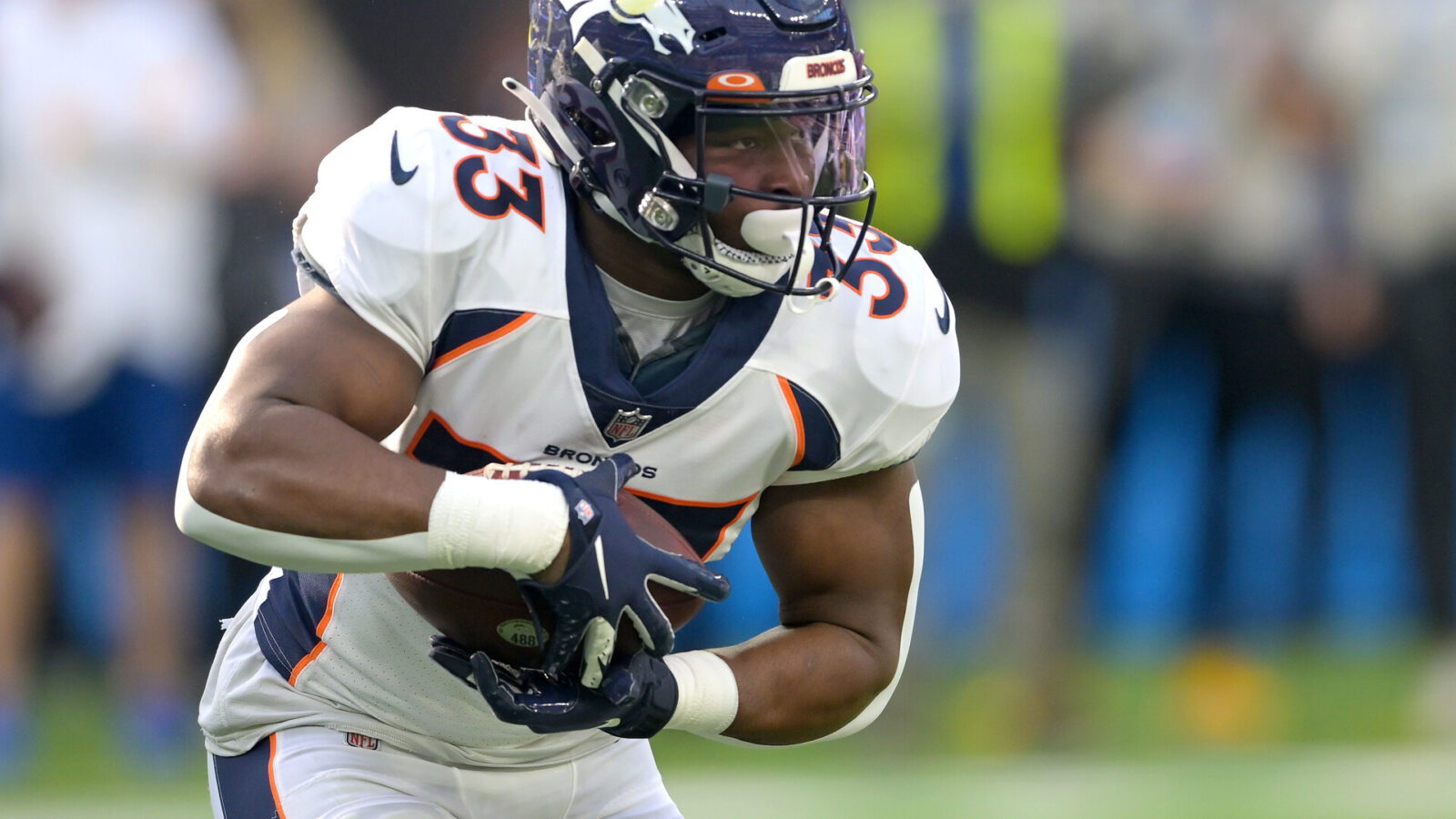 Denver Broncos running back Javonte Williams (33) carries the ball for a short gain in the first half against the Los Angeles Chargers at SoFi Stadium.