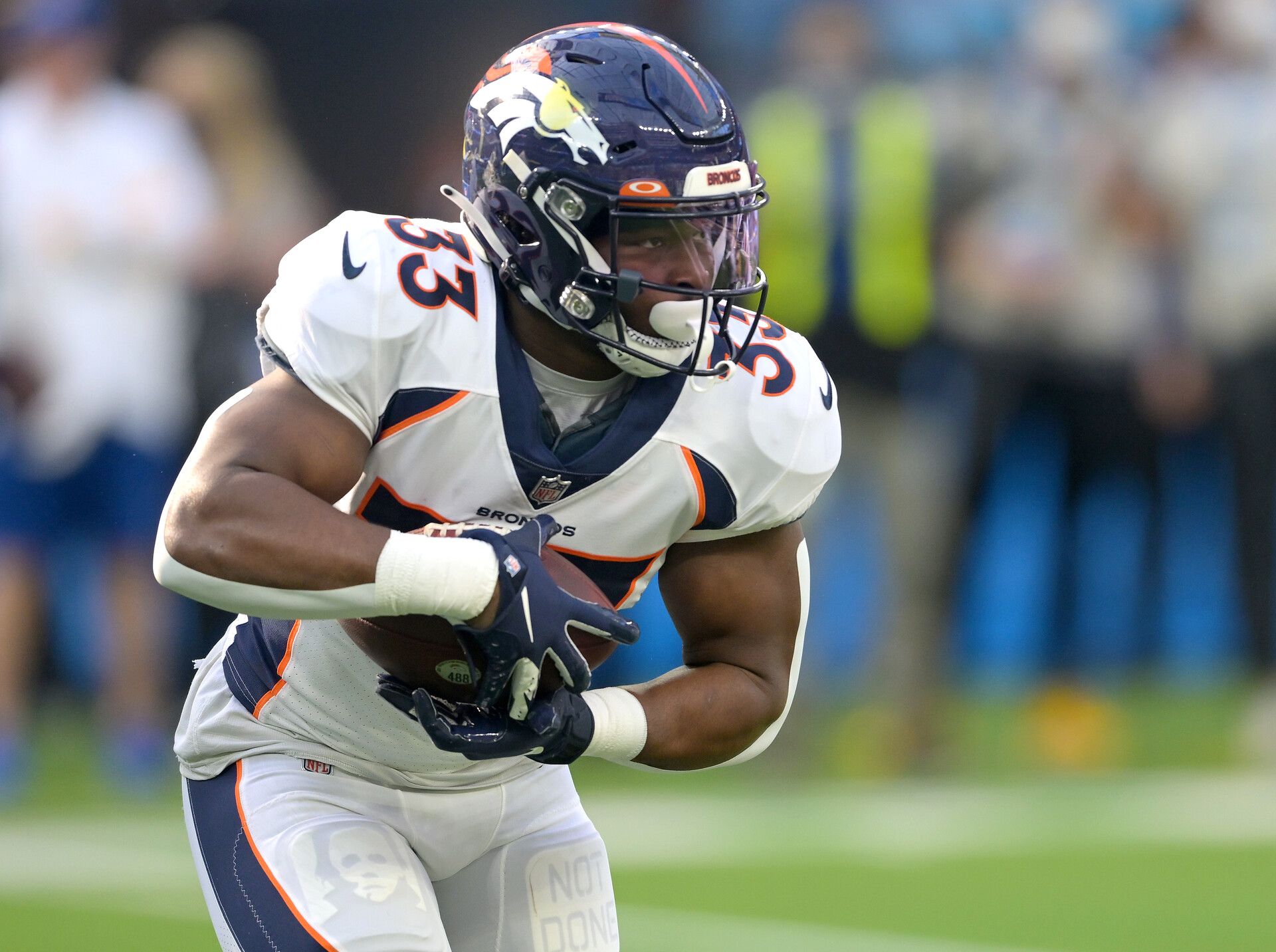 Denver Broncos running back Javonte Williams (33) carries the ball for a short gain in the first half against the Los Angeles Chargers at SoFi Stadium.