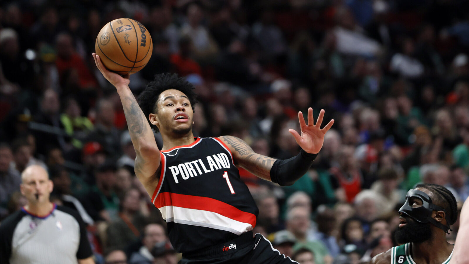 Mar 17, 2023; Portland, Oregon, USA; Portland Trail Blazers shooting guard Anfernee Simons (1) shoots the ball against Boston Celtics shooting guard Jaylen Brown (7) during the second half at Moda Center.
