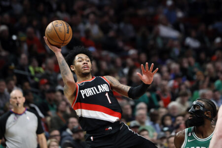 Mar 17, 2023; Portland, Oregon, USA; Portland Trail Blazers shooting guard Anfernee Simons (1) shoots the ball against Boston Celtics shooting guard Jaylen Brown (7) during the second half at Moda Center.