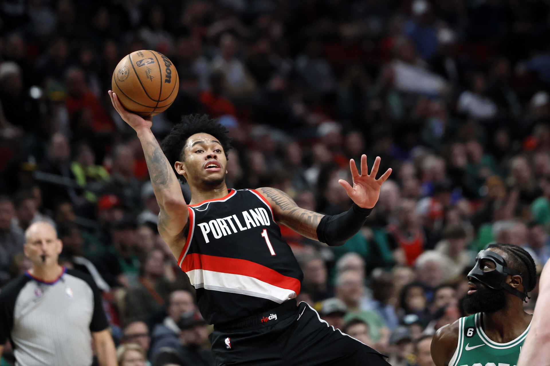 Mar 17, 2023; Portland, Oregon, USA; Portland Trail Blazers shooting guard Anfernee Simons (1) shoots the ball against Boston Celtics shooting guard Jaylen Brown (7) during the second half at Moda Center.