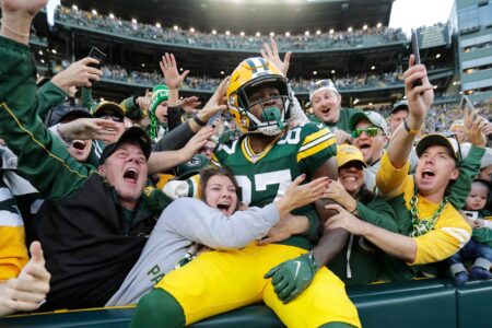Green Bay Packers wide receiver Romeo Doubs celebrates with fans after scoring a touchdown against the New England Patriots on Oct. 2 at Lambeau Field.