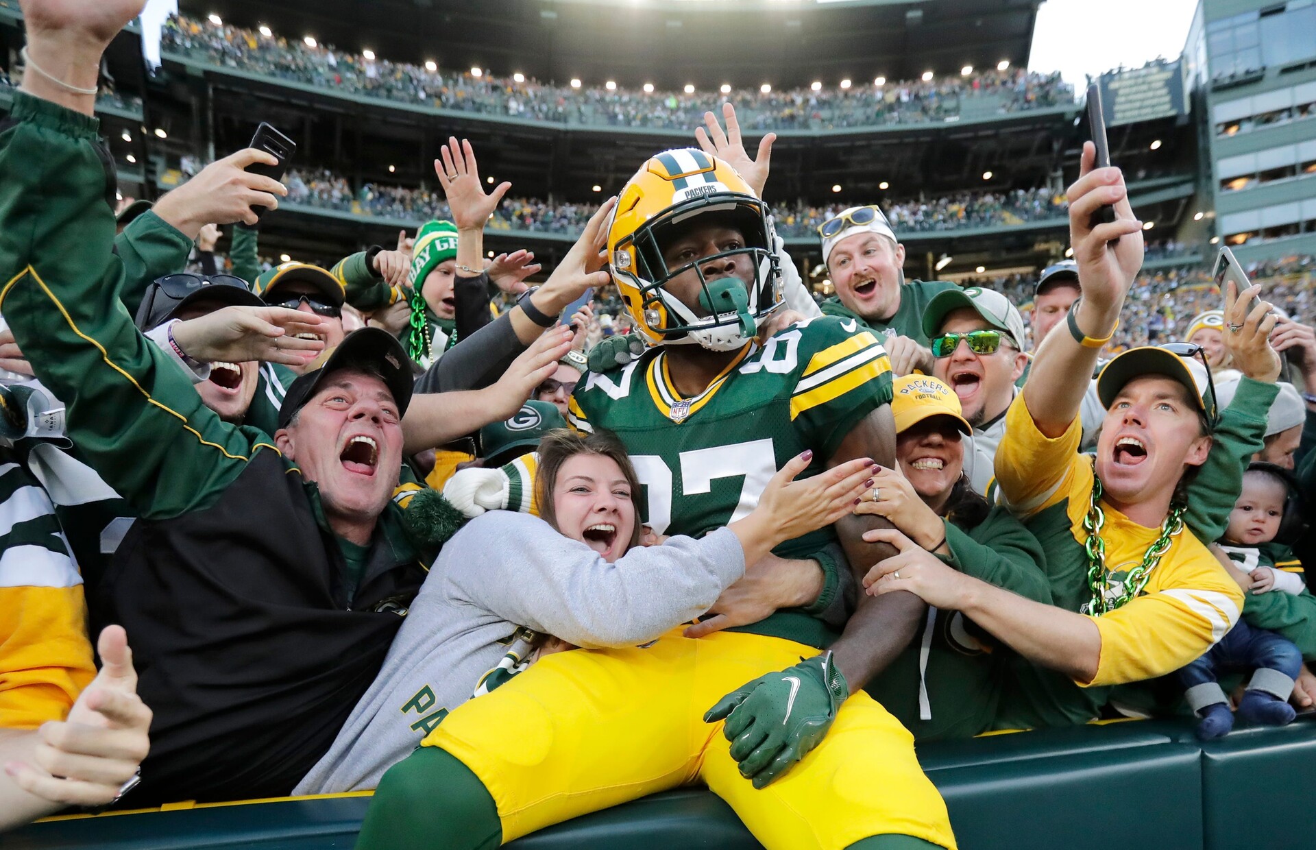 Green Bay Packers wide receiver Romeo Doubs celebrates with fans after scoring a touchdown against the New England Patriots on Oct. 2 at Lambeau Field.