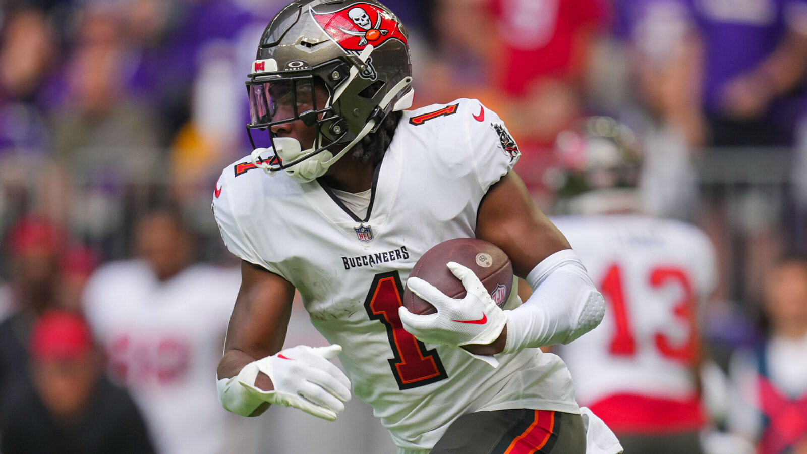 Tampa Bay Buccaneers running back Rachaad White (1) runs with the ball against the Minnesota Vikings in the second quarter at U.S. Bank Stadium.