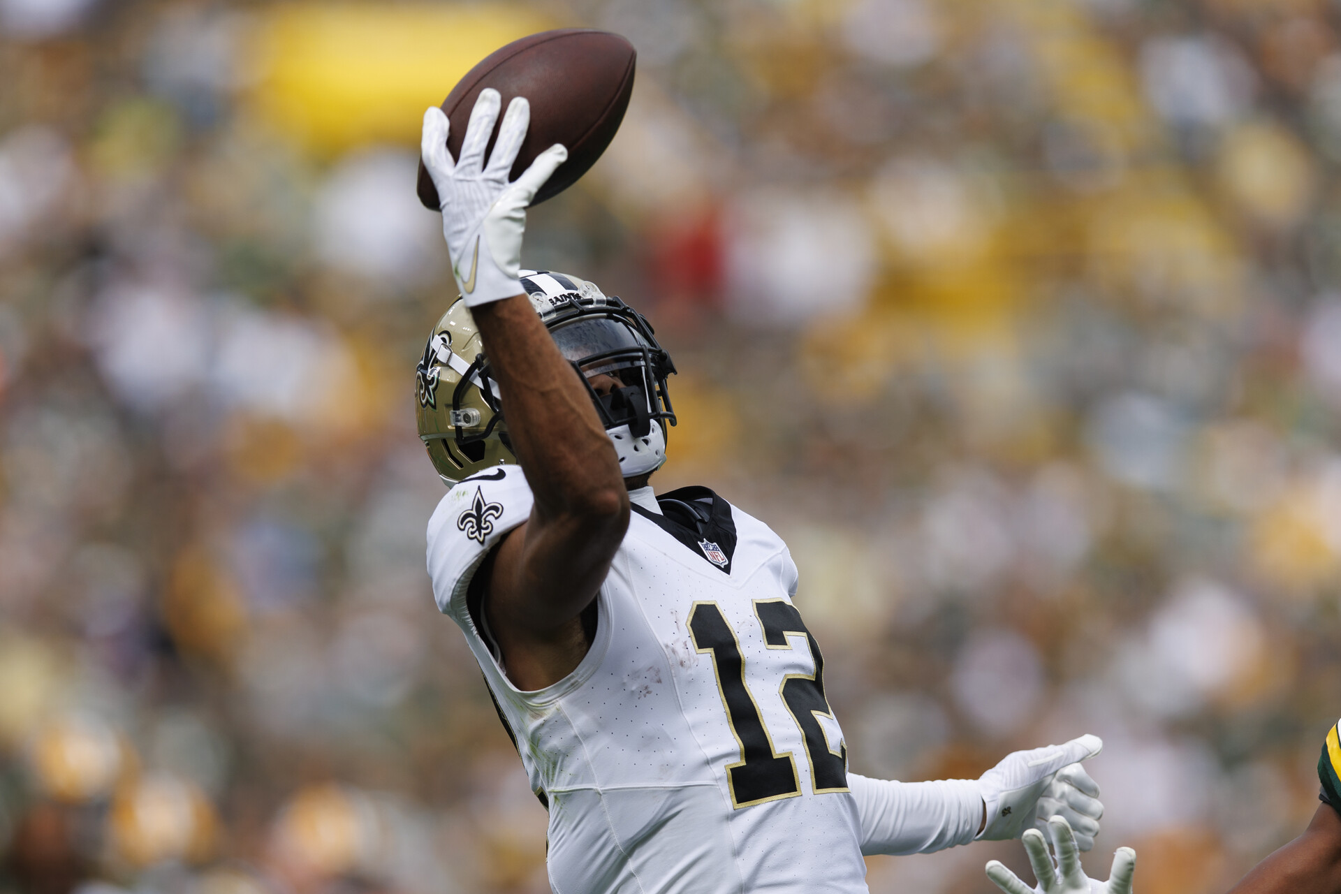 Sep 24, 2023; Green Bay, Wisconsin, USA; New Orleans Saints wide receiver Chris Olave (12) reaches to catch a pass during the second quarter against the Green Bay Packers at Lambeau Field.