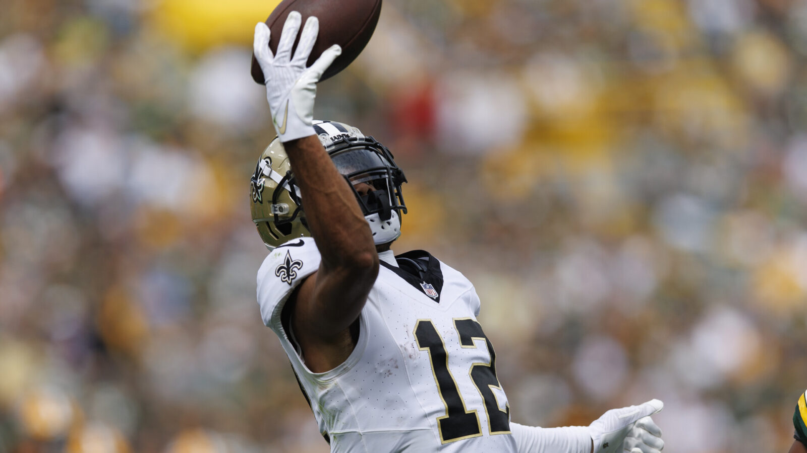 Sep 24, 2023; Green Bay, Wisconsin, USA; New Orleans Saints wide receiver Chris Olave (12) reaches to catch a pass during the second quarter against the Green Bay Packers at Lambeau Field.
