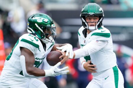 New York Jets quarterback Zach Wilson (2) hands the ball to running back Breece Hall (20) in the first half against the New England Patriots at MetLife Stadium on Sunday, Sept. 24, 2023, in East Rutherford.