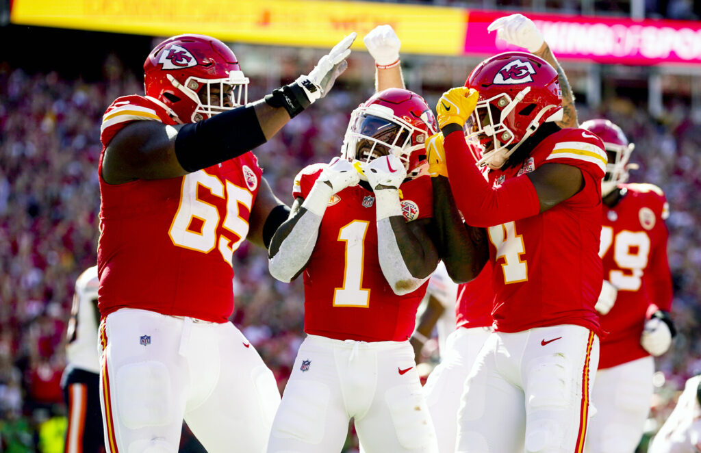 Kansas City Chiefs running back Jerick McKinnon (1) celebrates with guard Trey Smith (65) and wide receiver Rashee Rice (4) after scoring a touchdown against the Chicago Bears during the first half at GEHA Field at Arrowhead Stadium.