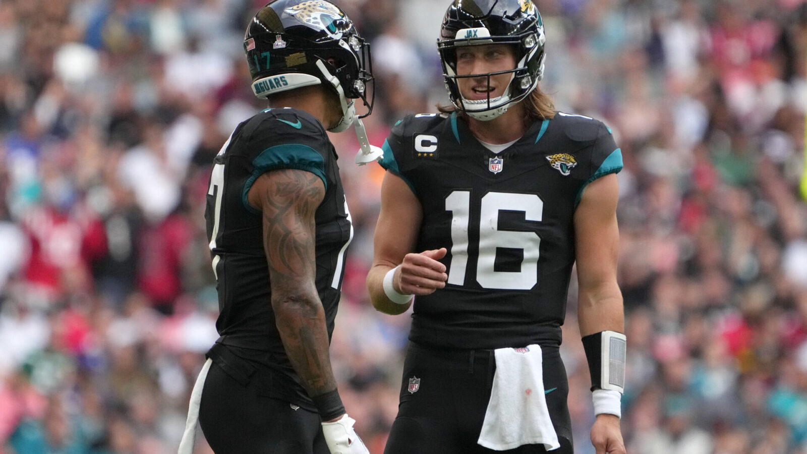 Oct 1, 2023; London, United Kingdom; Jacksonville Jaguars quarterback Trevor Lawrence (16) talks with tight end Evan Engram (17) against the Atlanta Falcons in the first half during an NFL International Series game at Wembley Stadium.