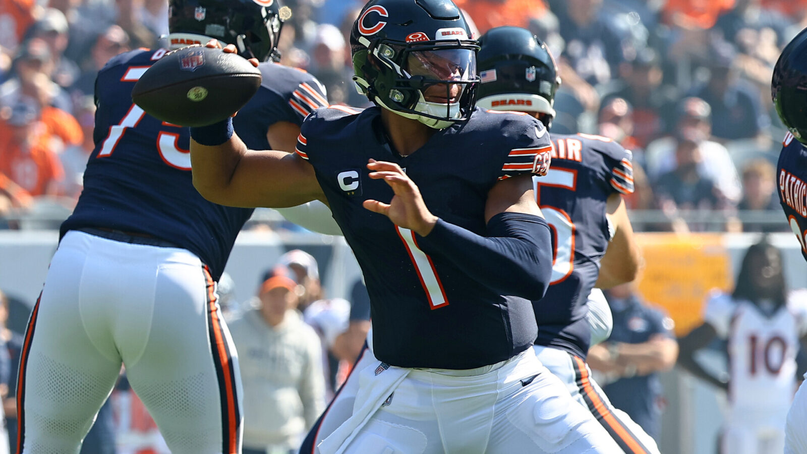 Oct 1, 2023; Chicago, Illinois, USA; Chicago Bears quarterback Justin Fields (1) drops back to pass/ against the Denver Broncos during the first half at Soldier Field.