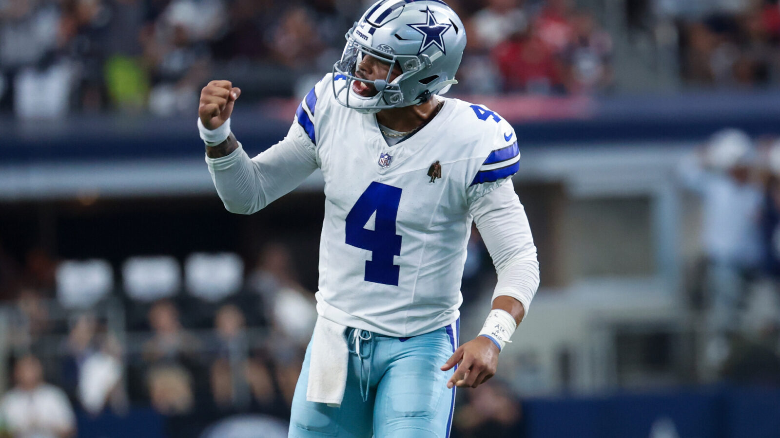 Oct 1, 2023; Arlington, Texas, USA; Dallas Cowboys quarterback Dak Prescott (4) reacts after throwing a touchdown pass during the first quarter against the New England Patriots at AT&T Stadium.