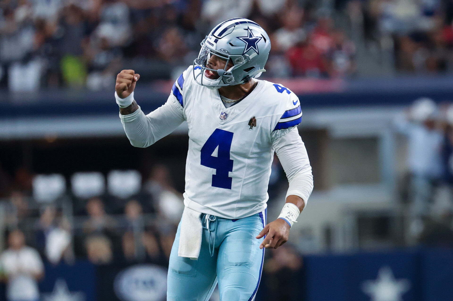 Oct 1, 2023; Arlington, Texas, USA; Dallas Cowboys quarterback Dak Prescott (4) reacts after throwing a touchdown pass during the first quarter against the New England Patriots at AT&T Stadium.