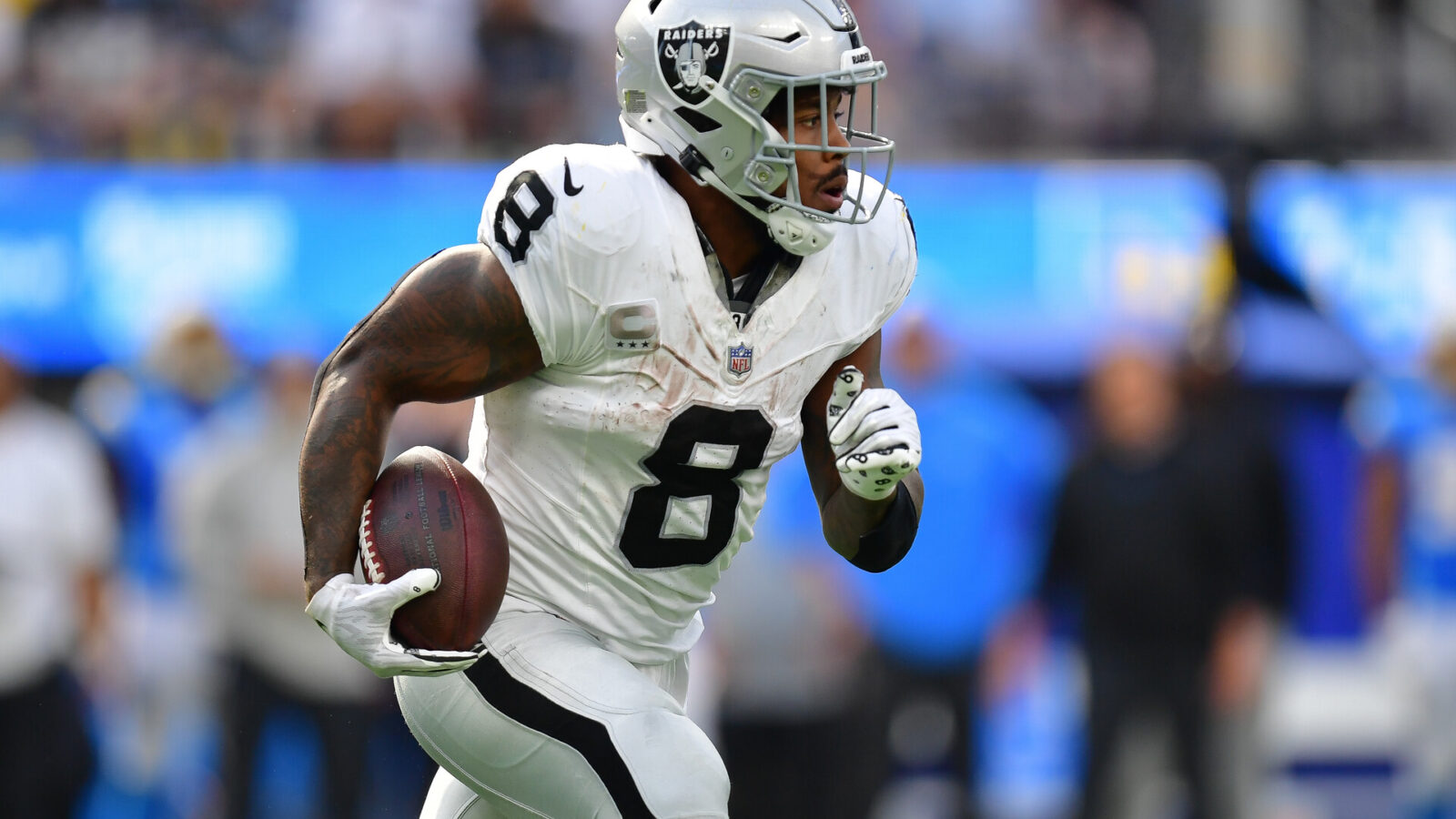 Las Vegas Raiders running back Josh Jacobs (8) runs the ball against the Los Angeles Chargers during the second half at SoFi Stadium.