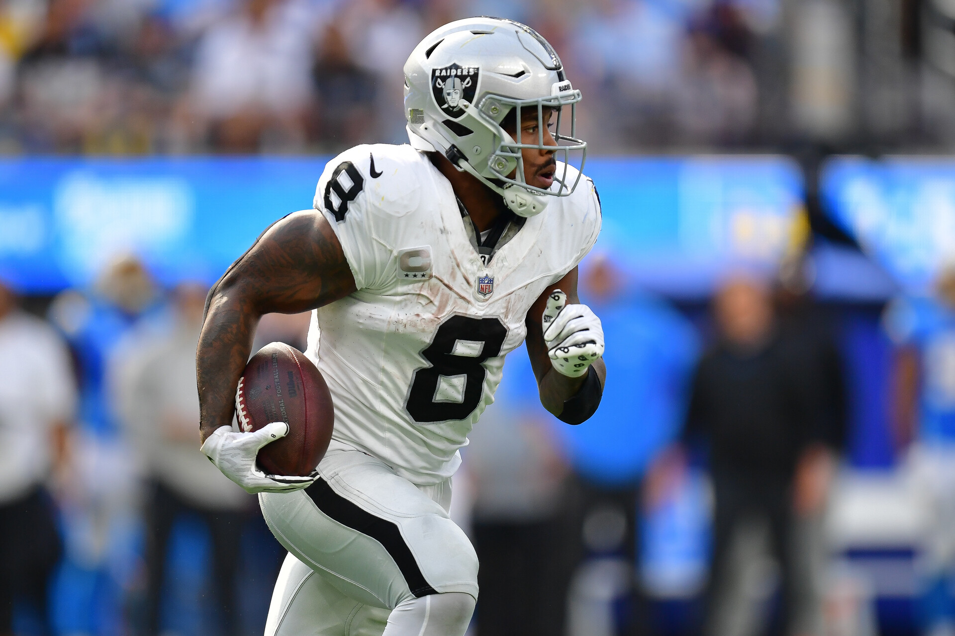 Las Vegas Raiders running back Josh Jacobs (8) runs the ball against the Los Angeles Chargers during the second half at SoFi Stadium.