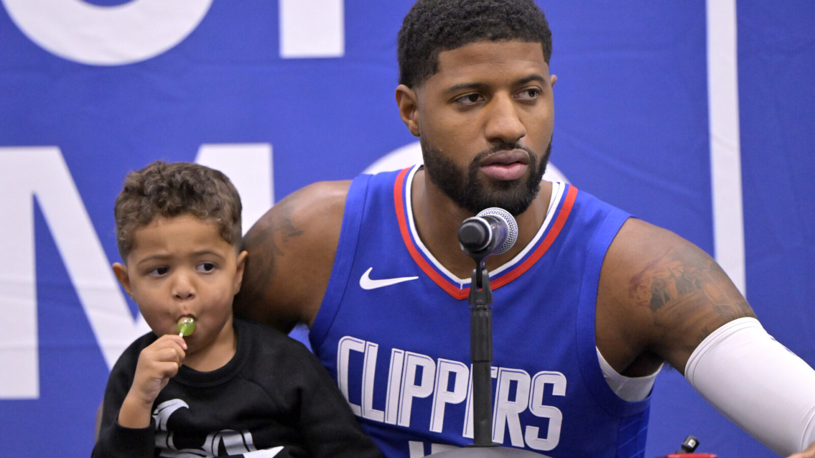 Oct 2, 2023; Los Angeles, CA, USA; Los Angeles Clippers forward Paul George (13) with his two year old son Paul Vuk George, during a new conference on media day at the Honey Training Center in Playa Vista, CA